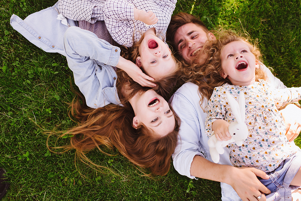 cheerful family lying on the grass